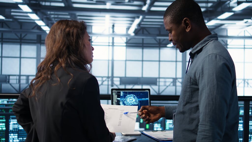 ai server room admins looking over financial documents, using tablet